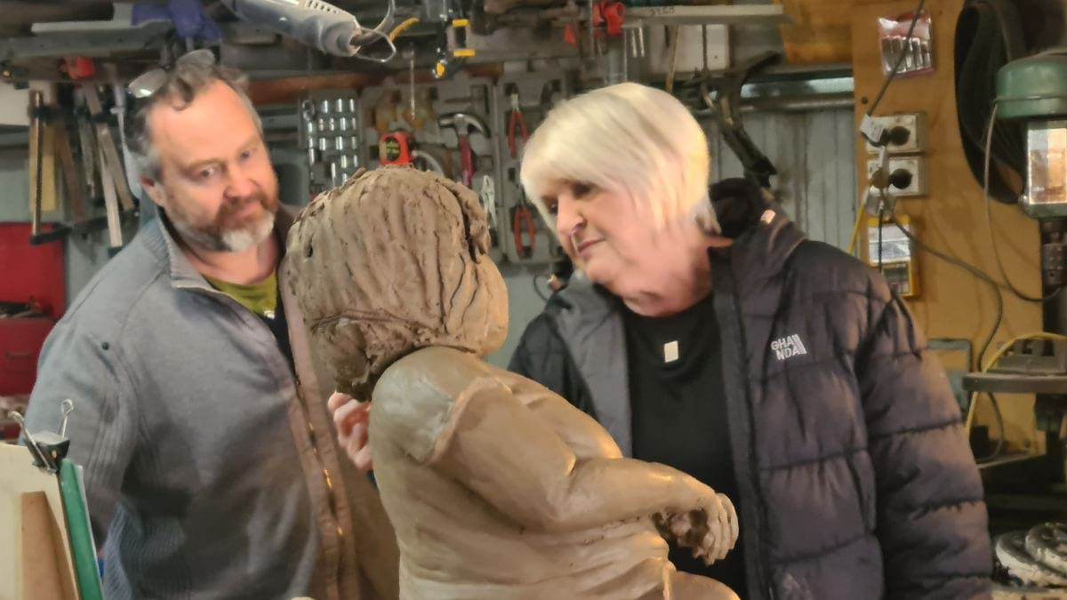 Sculptor Daniel Fraser and Lynne Young, Stella&rsquo;s Mum, touching up the hair on the clay sculpture of Stella.